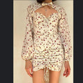 Sabo Skirt Cream and pink floral mini dress with a ruched front and tie up detail