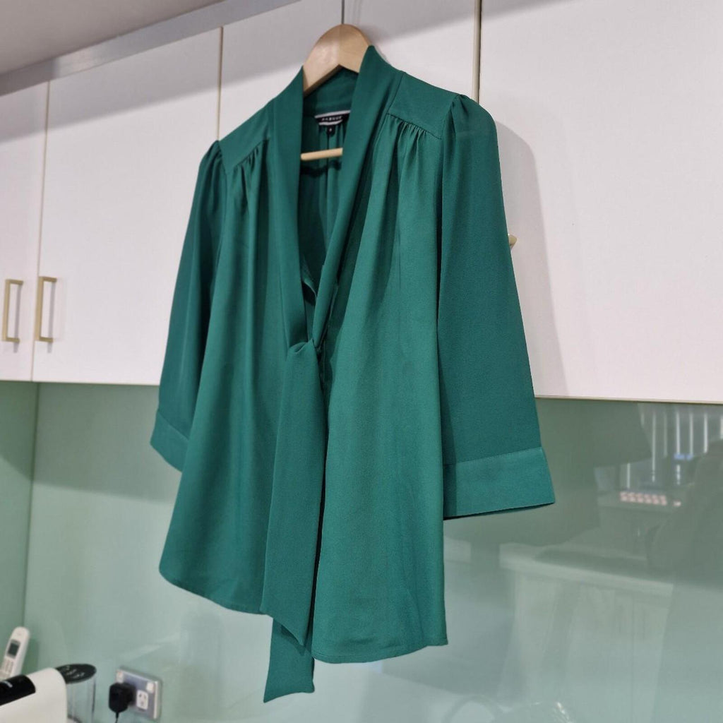 Basque green sheer blouse with tie detail.