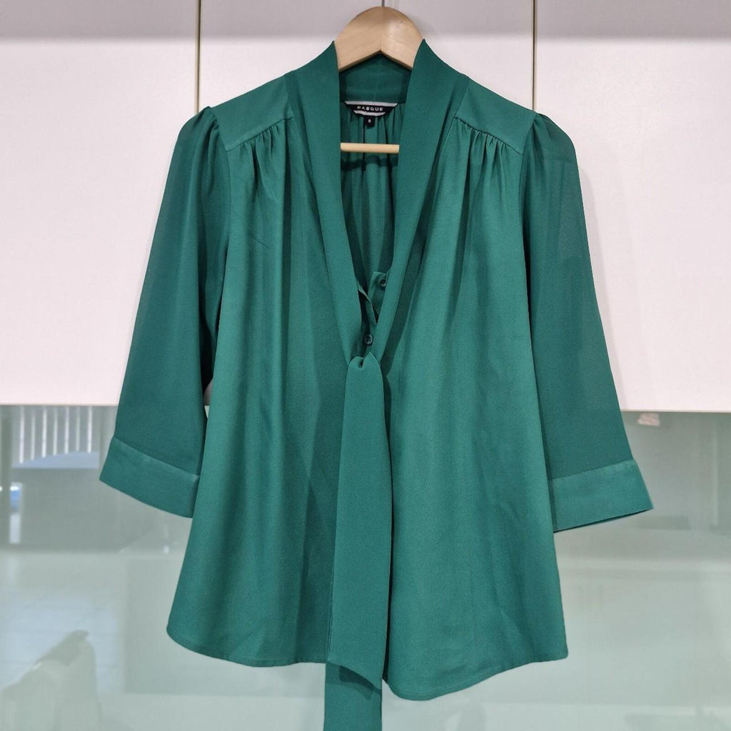 Basque green sheer blouse with tie detail.