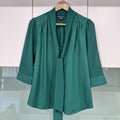 Basque green sheer blouse with tie detail.