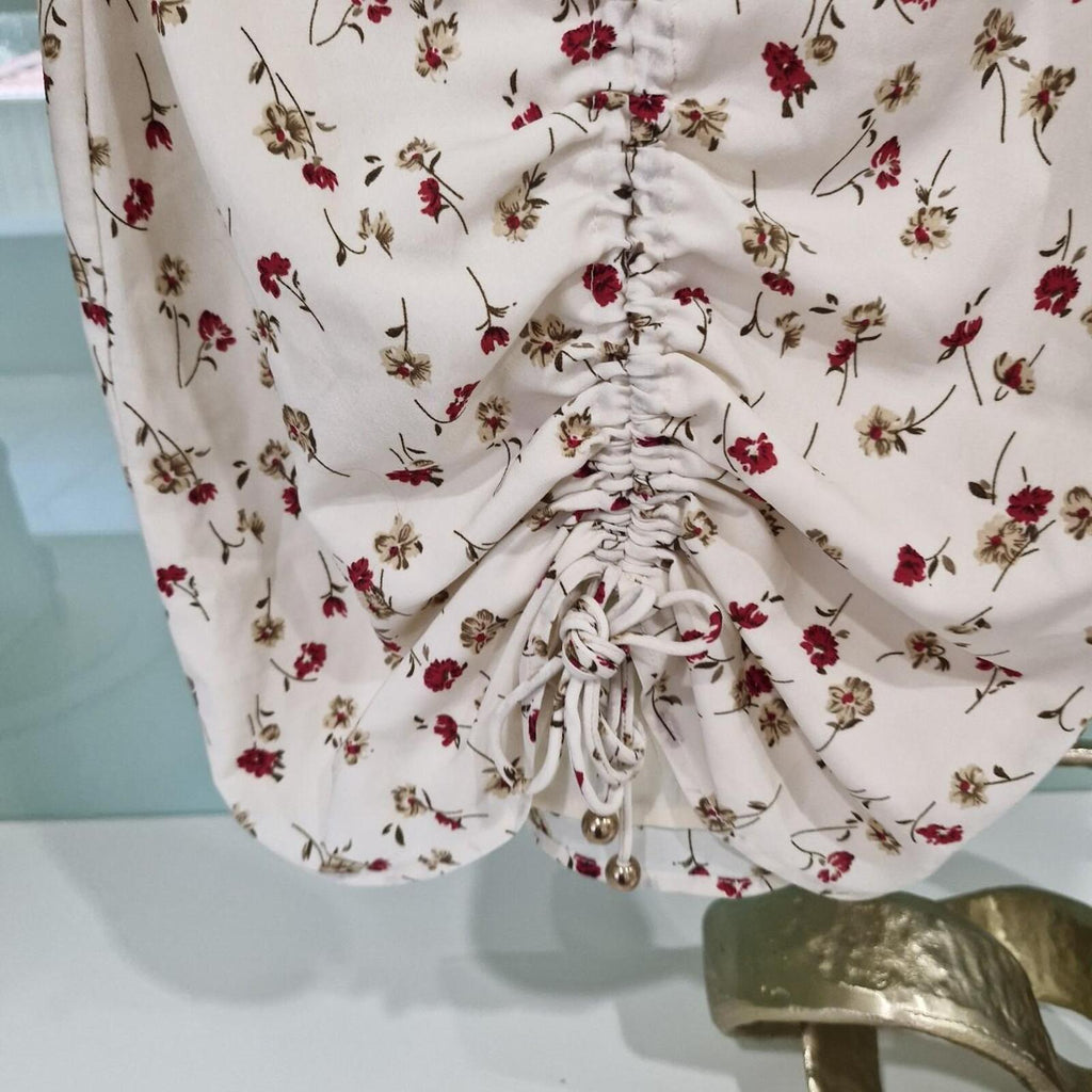 Sabo Skirt Cream and pink floral mini dress with a ruched front and tie up detail