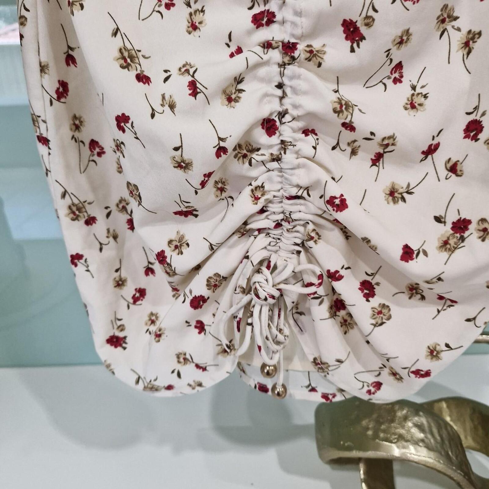 Sabo Skirt Cream and pink floral mini dress with a ruched front and tie up detail