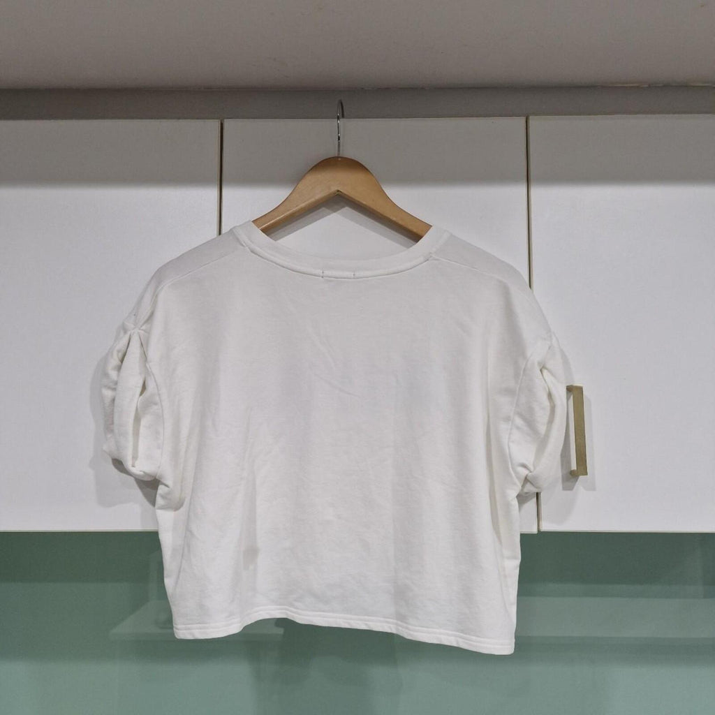 Jaspal white cropped top with black lettering and heart detail.