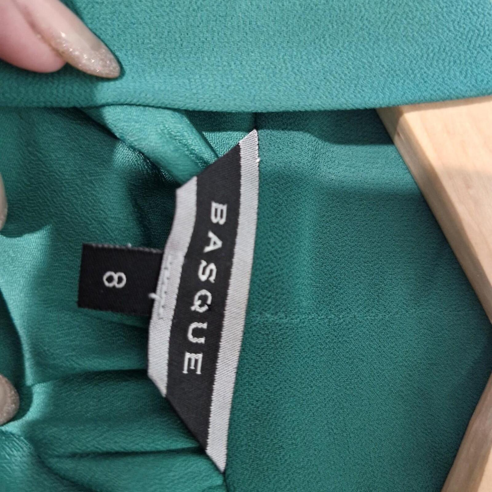 Basque green sheer blouse with tie detail.