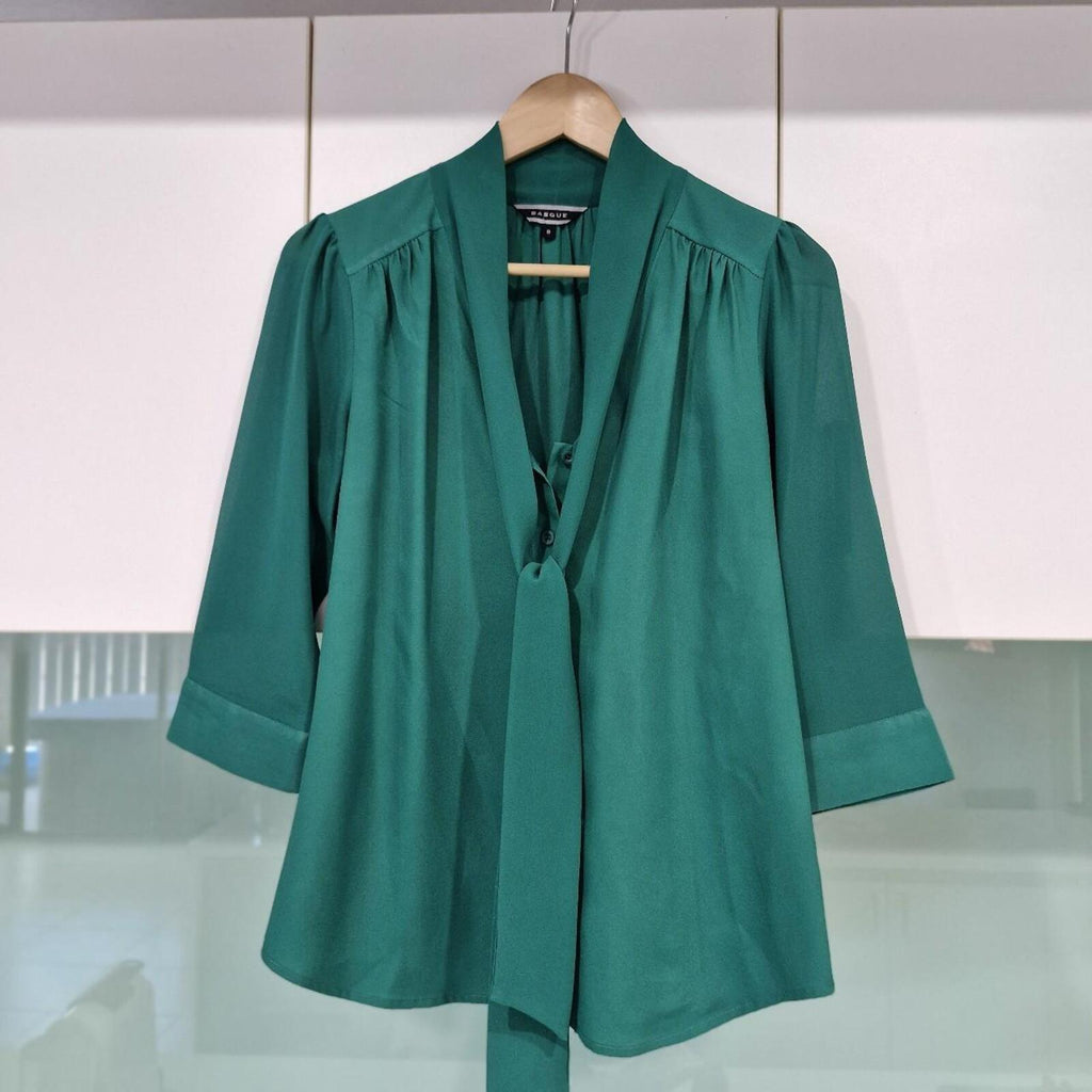 Basque green sheer blouse with tie detail.