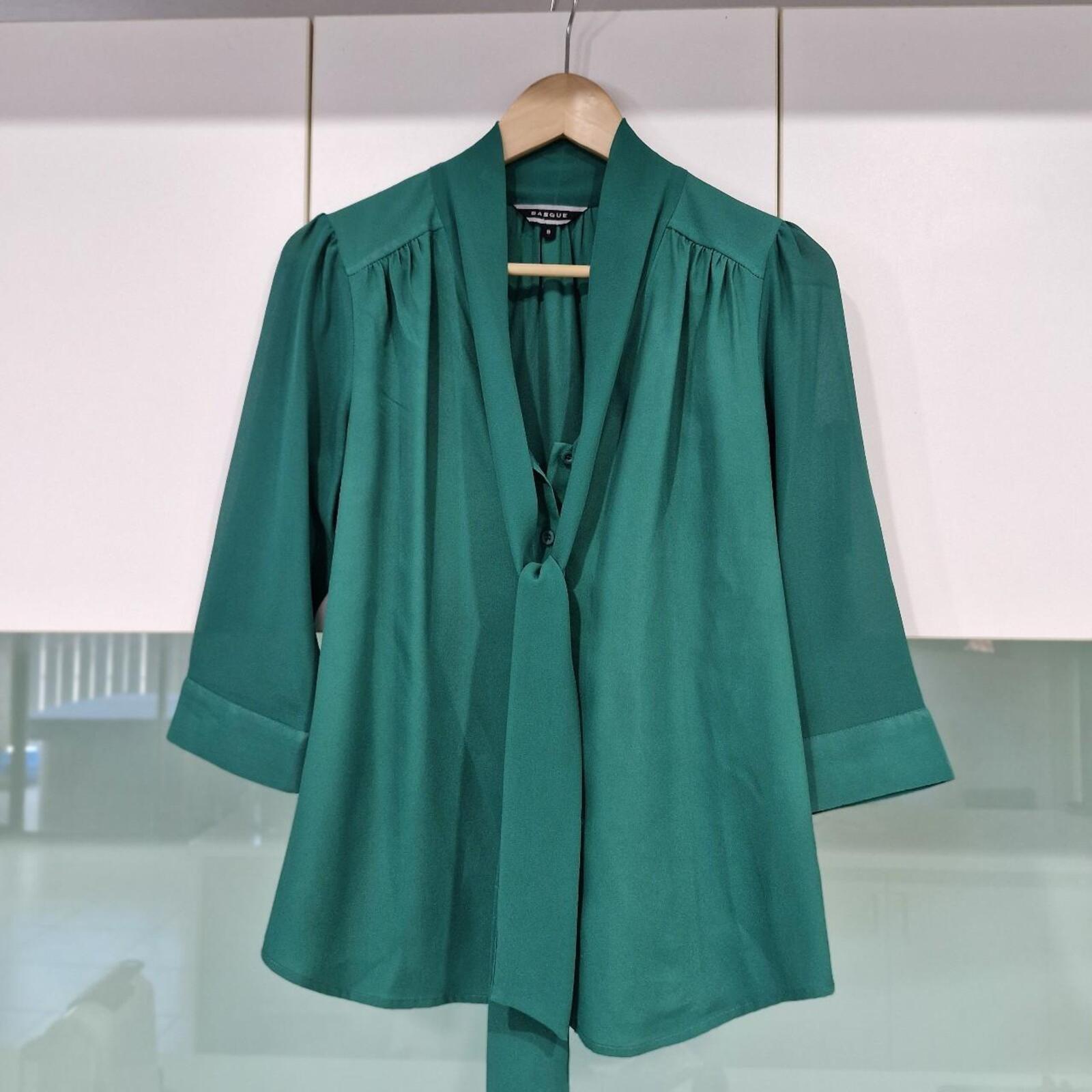 Basque green sheer blouse with tie detail.