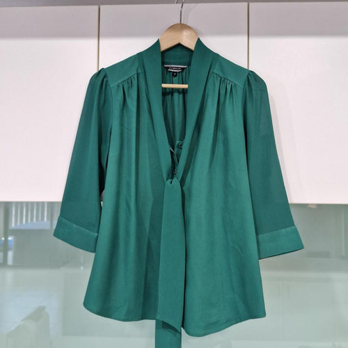 Basque green sheer blouse with tie detail.