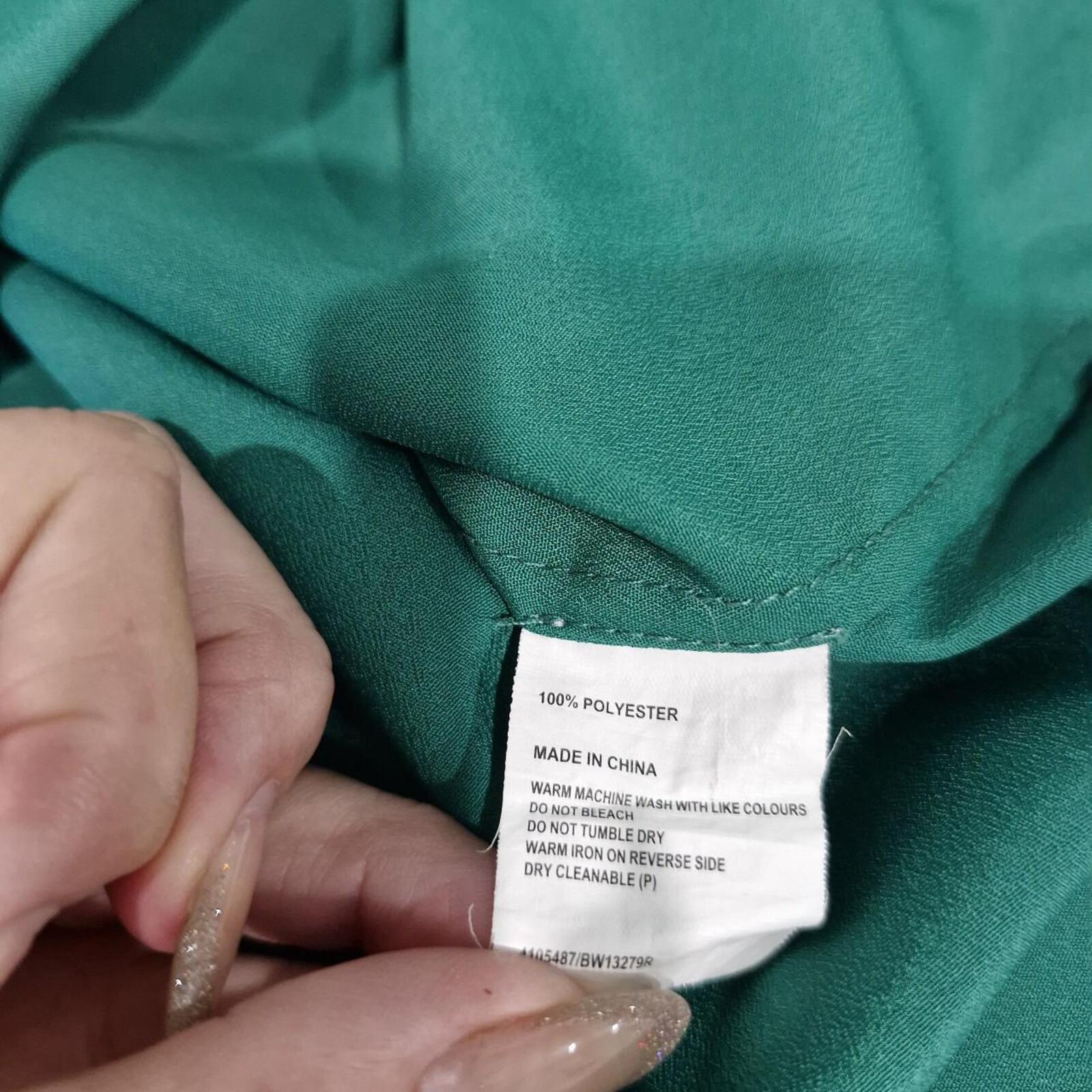 Basque green sheer blouse with tie detail.