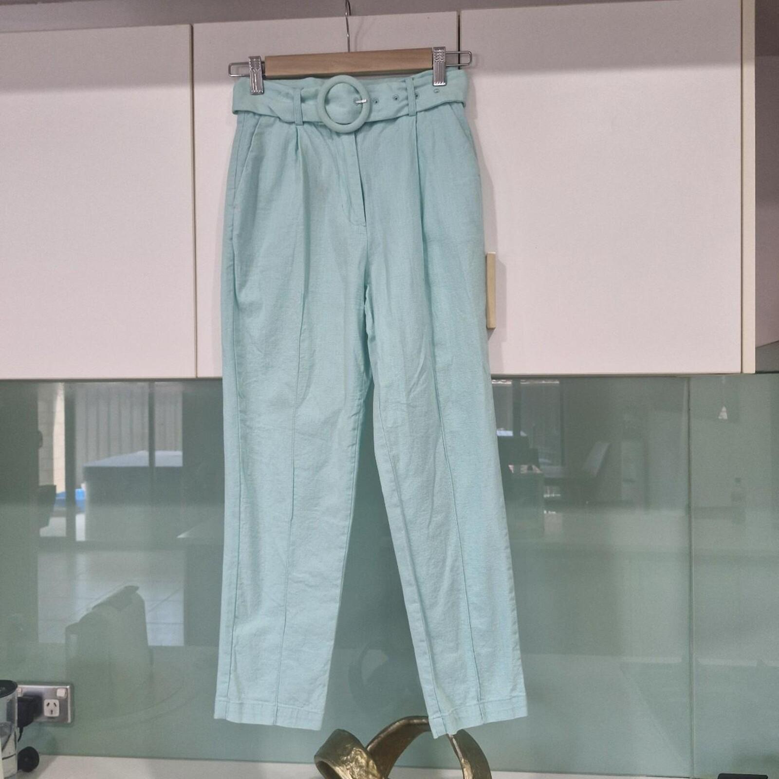 Seven Wonders mint green capri trousers with belt.
