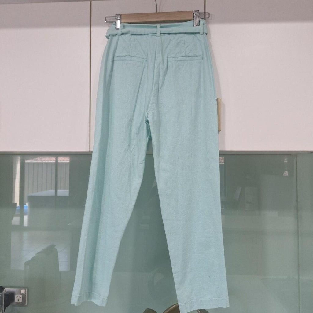 Seven Wonders mint green capri trousers with belt.