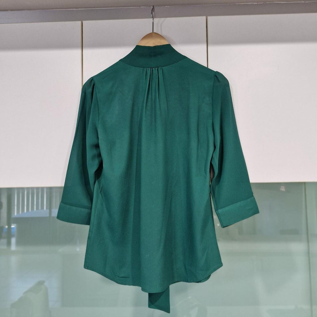 Basque green sheer blouse with tie detail.