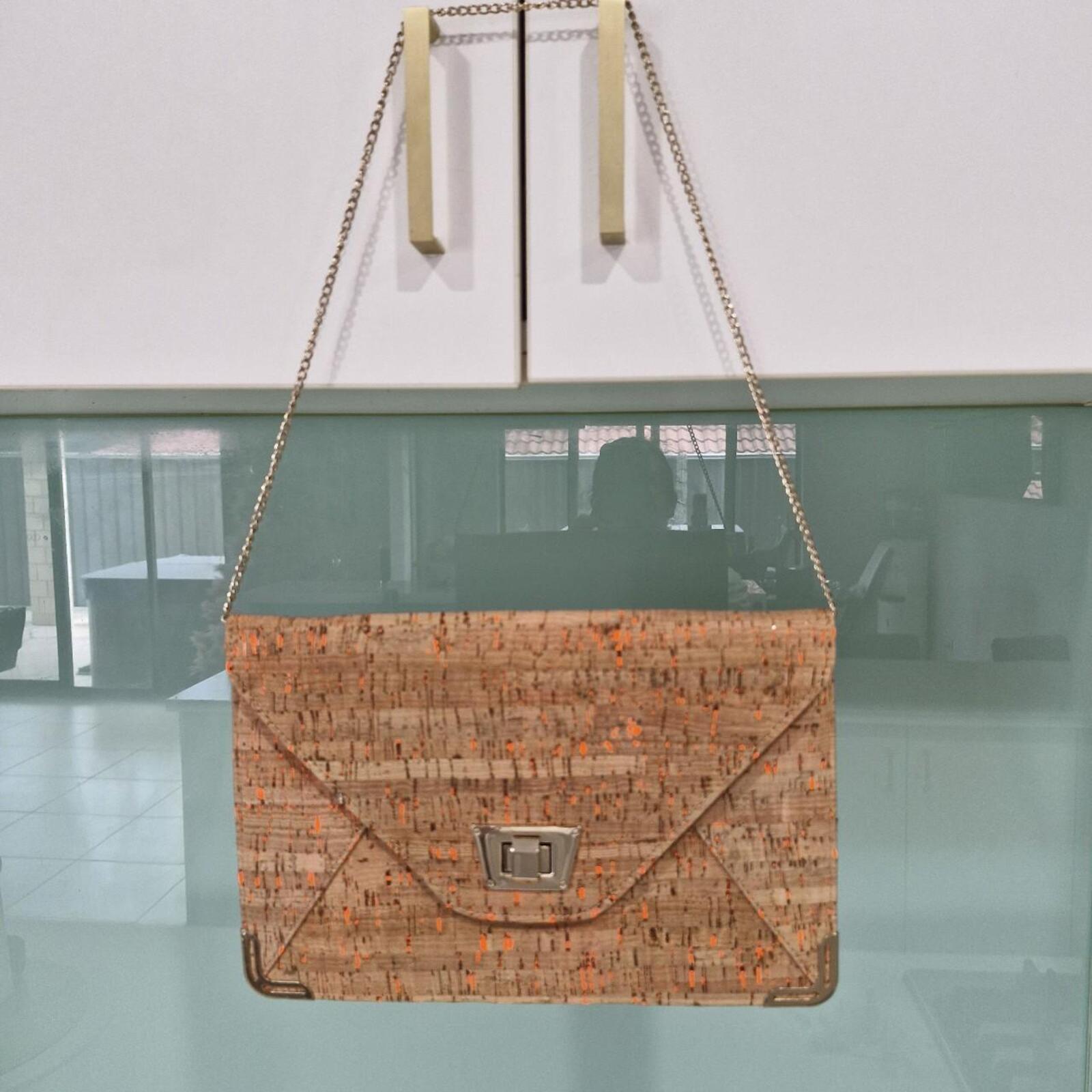 Tan and orange cork clutch bag with gold chain strap
