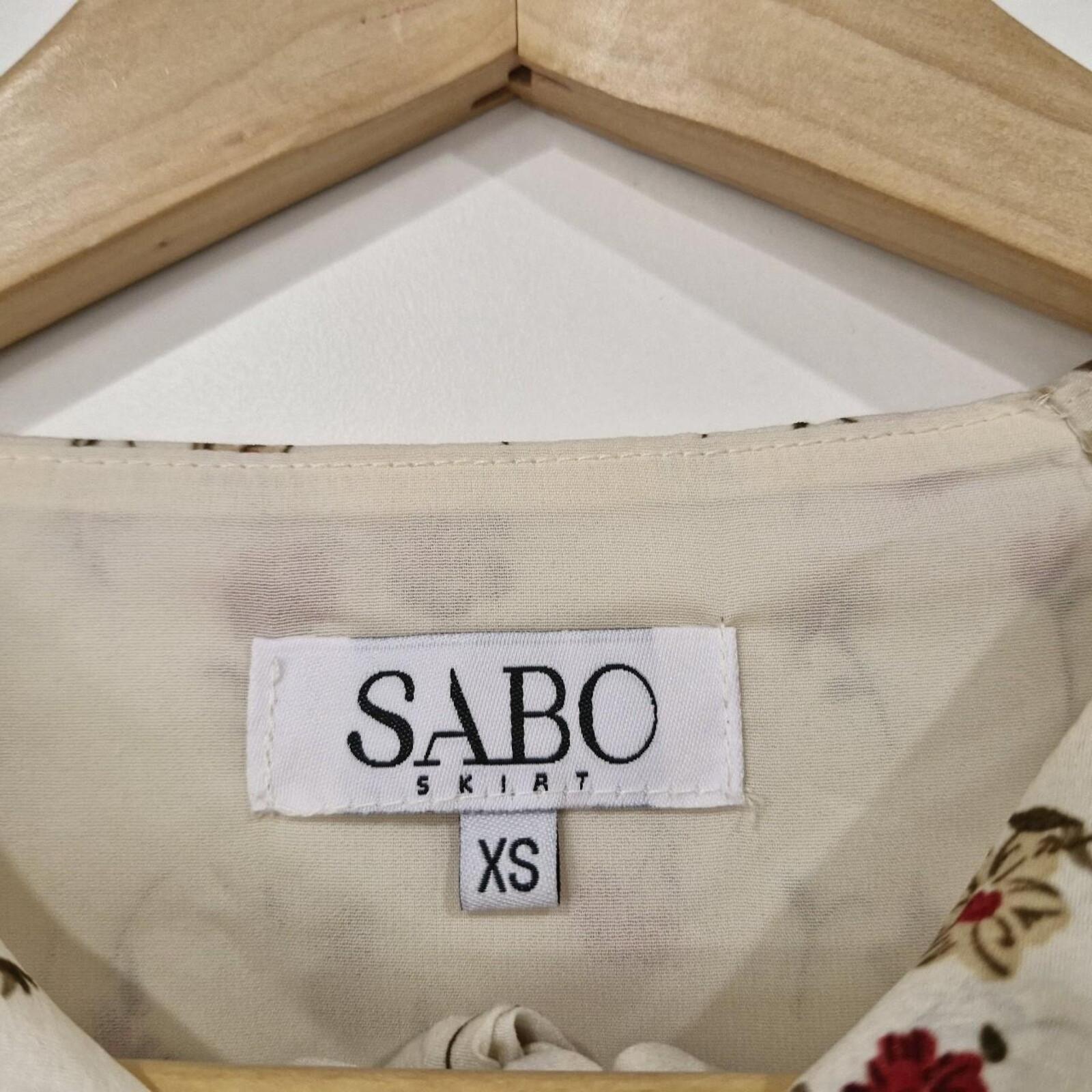 Sabo Skirt Cream and pink floral mini dress with a ruched front and tie up detail